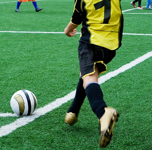 Soccer player on field line going for a kick