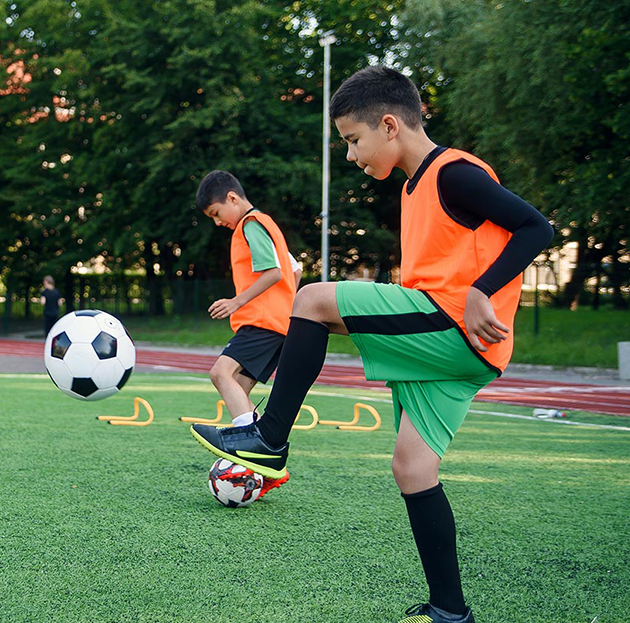 Soccer players practicing dribbles